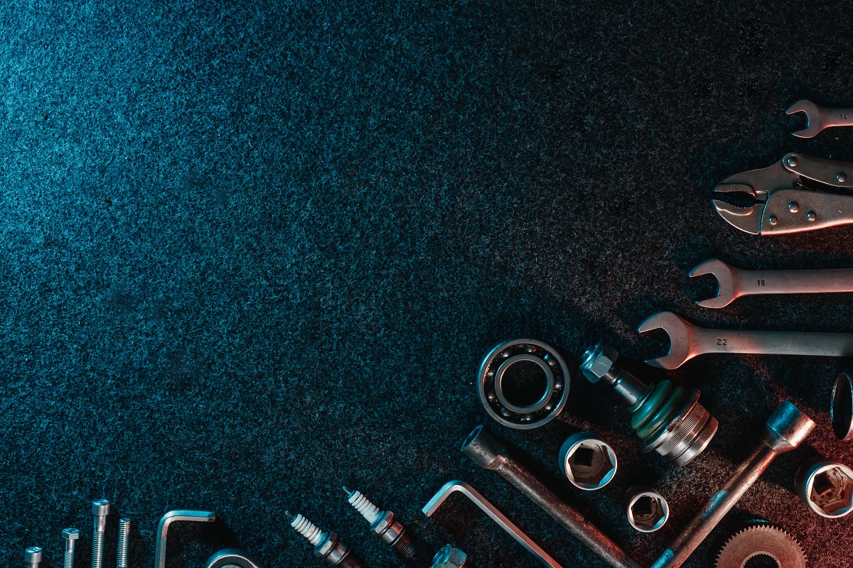 Bearings, wrenches, bolts on a dark background. view from above. Flat design. Automotive subjects. Copy space.