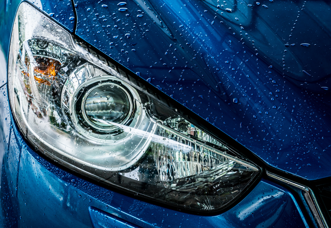 Close up of the headlights of a blue car