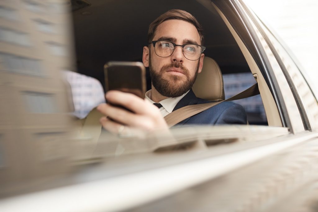 Man using phone in the car