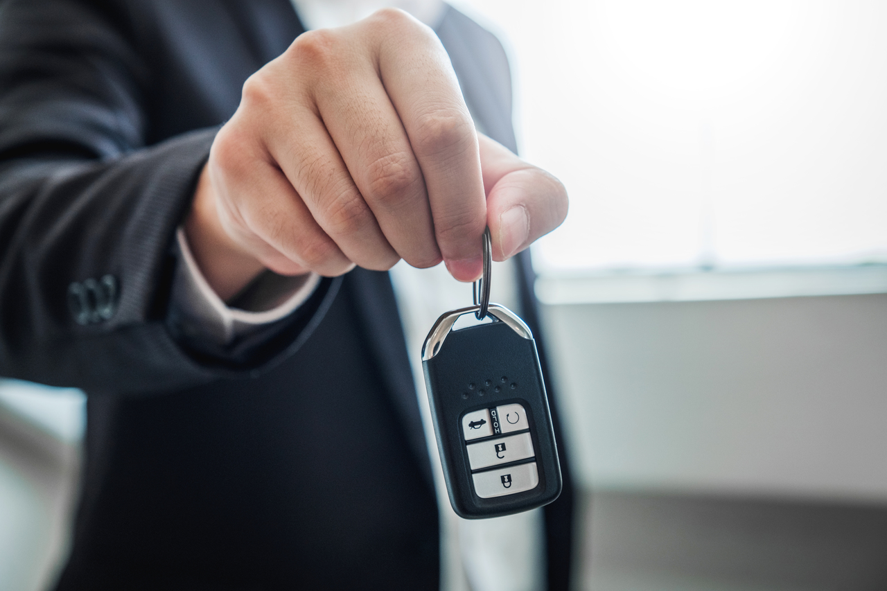 Sale agent giving Car key to customer