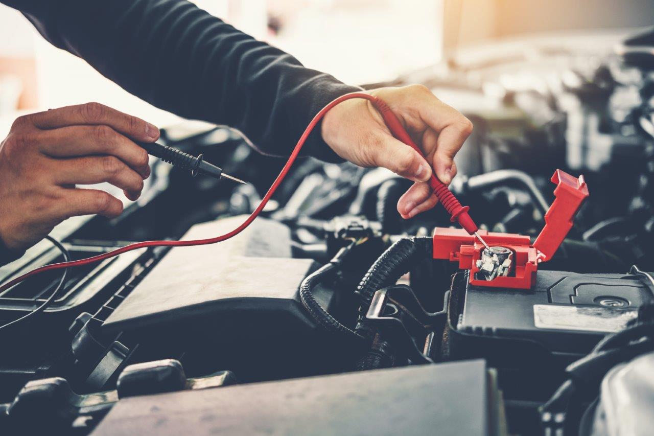 man checking car battery