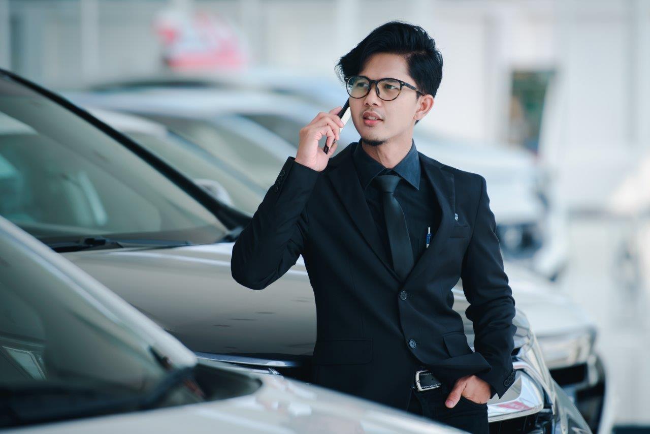 man in suit buying car